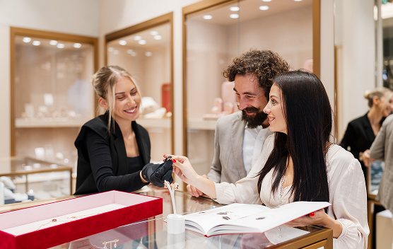 Couple shopping for luxury jewelry with sales assistant
